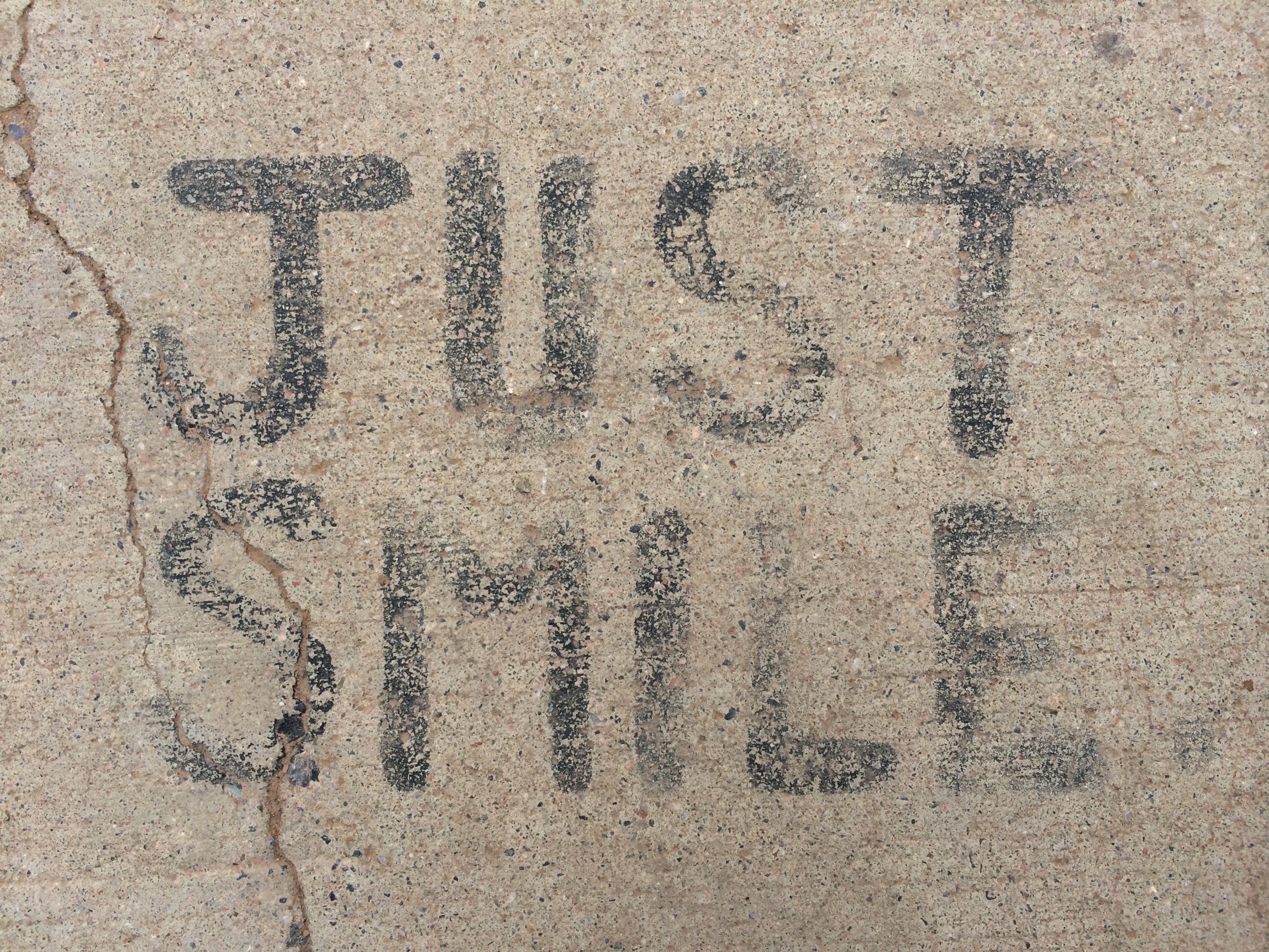 JUST SMILE sign telling about the best approach to life